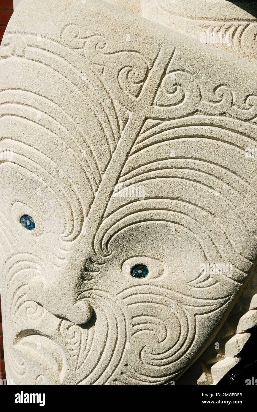 Wellington New Zealand - October 2 2010: closeup Maori face carving in sandstone in botanic gardens Stock Photo