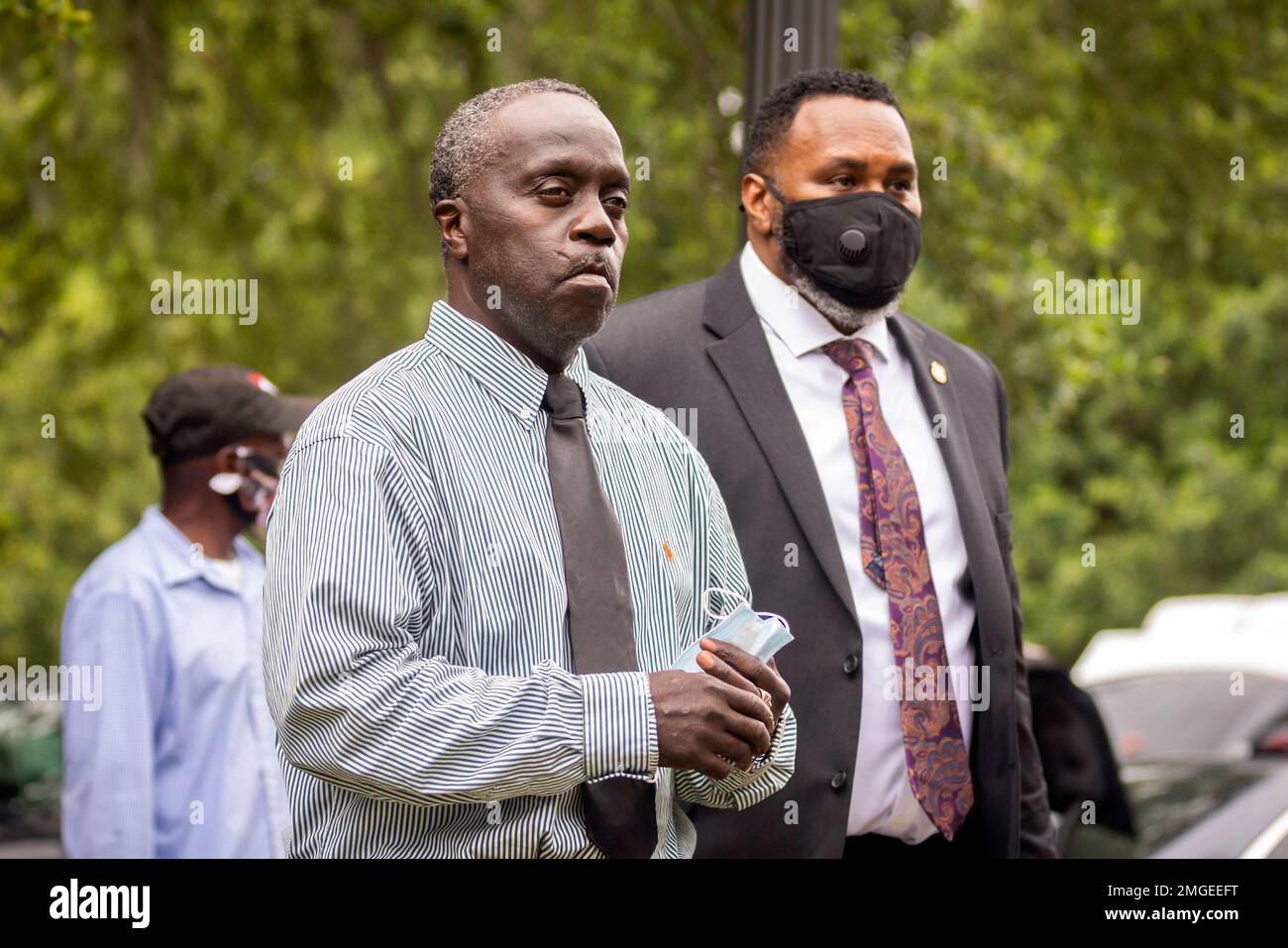 Ahmaud Arbery's father, Marcus Aubrey, center, walks away from the