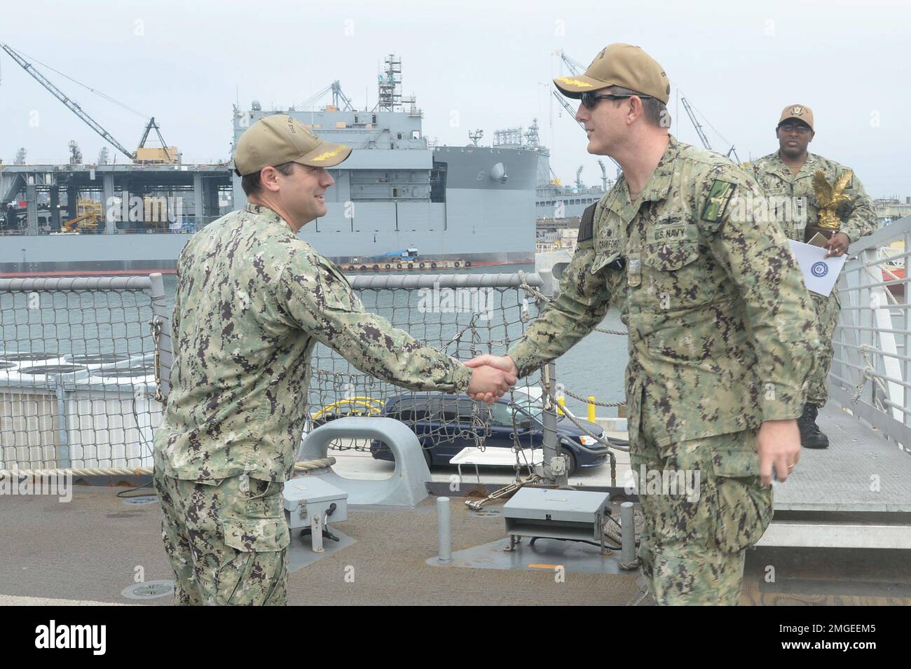 220824-N-ZS023-1002 SAN DIEGO (Aug. 24, 2022) Cmdr. Jerimiah Peterson, left, commanding officer of Freedom-variant littoral combat ship USS Fort Worth (LCS 3), greets Capt. Marc Crawford, commodore of Littoral Combat Ship Squadron ONE , upon arrival to Fort Worth. LCS are fast, agile, mission-focused platforms designed to operate in near-shore environments, winning against 21st-century coastal threats. LCS support forward-presence, maritime security, sea control, and deterrence missions around the globe. Stock Photo