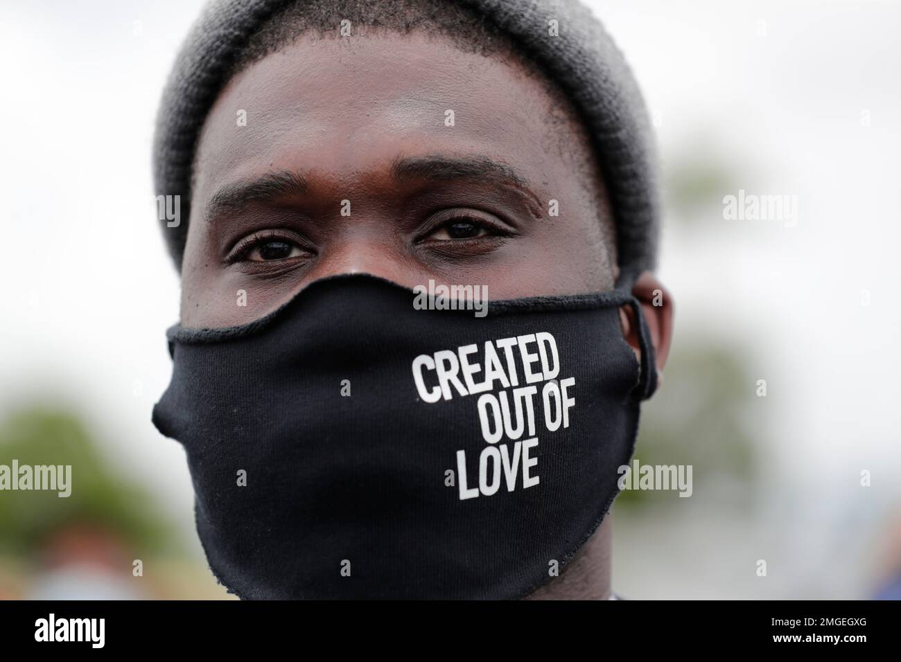 Mario Aristil wears a protective face mask before a police escorted
