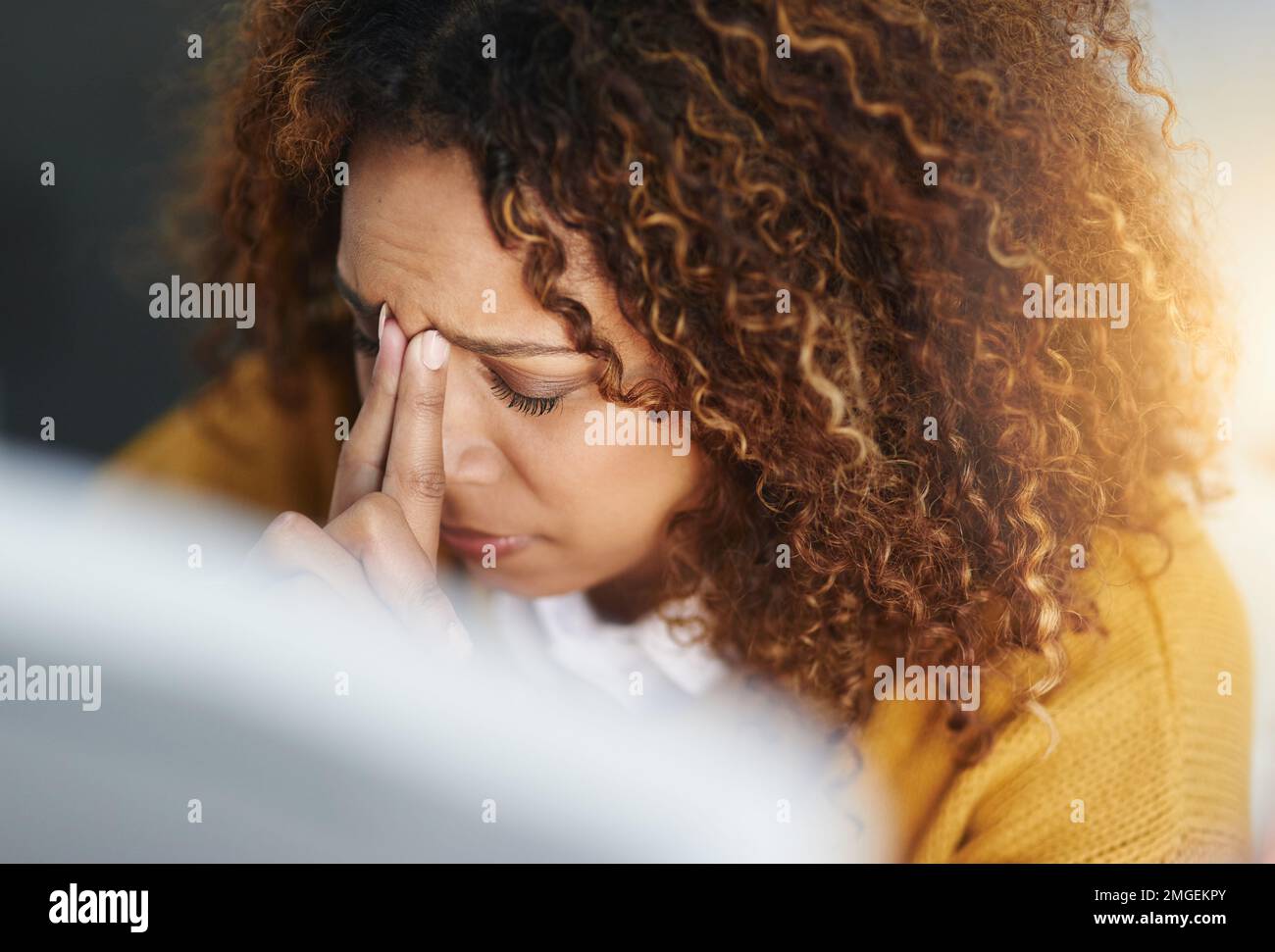 Think hard. a stressed young businesswoman sitting and working in the office at work. Stock Photo