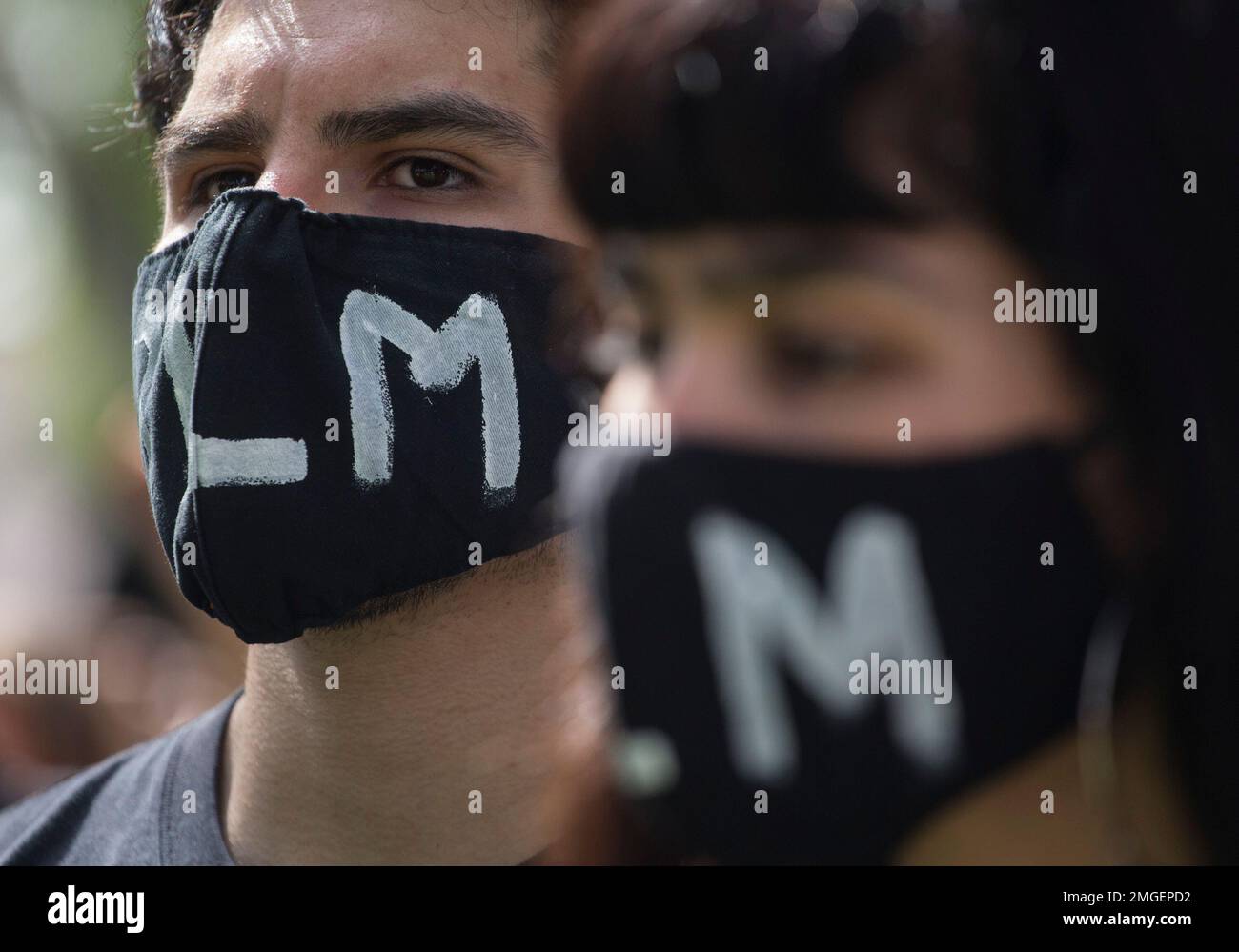 Demonstrators wearing masks in a protest over the death of George Floyd ...