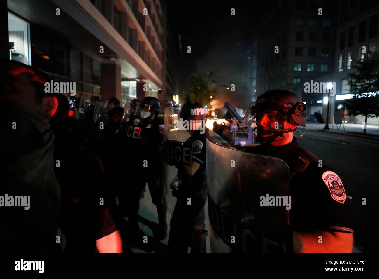 Authorities in riot gear watch as demonstrators gather to protest the ...