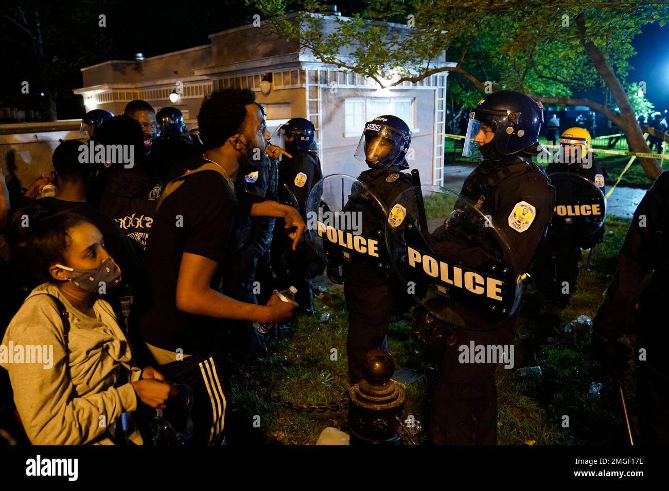 Demonstrators vent to police in riot gear as they protest the death of ...