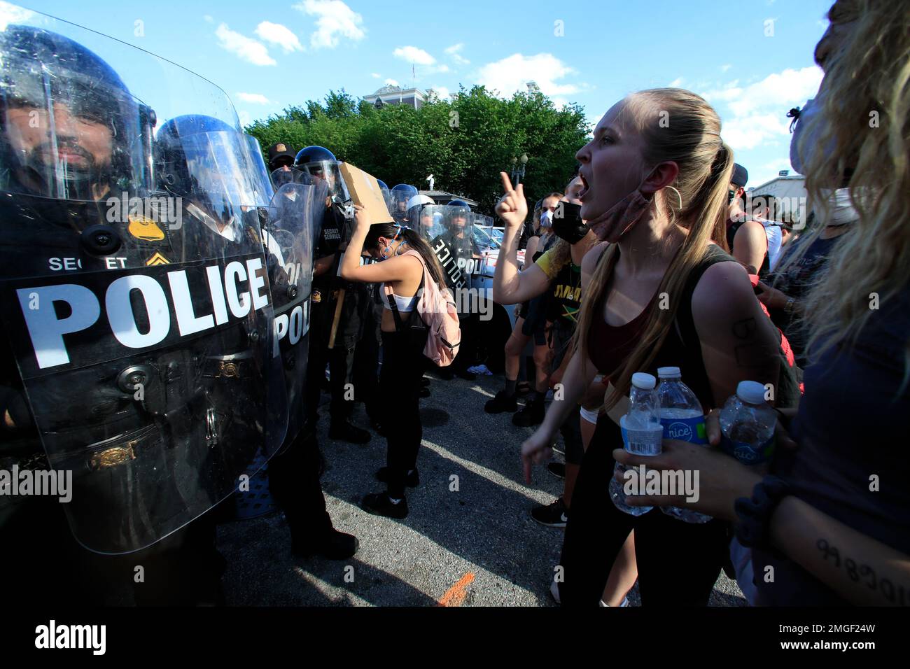 Demonstrators vent to police in riot gear as they protest the death of ...