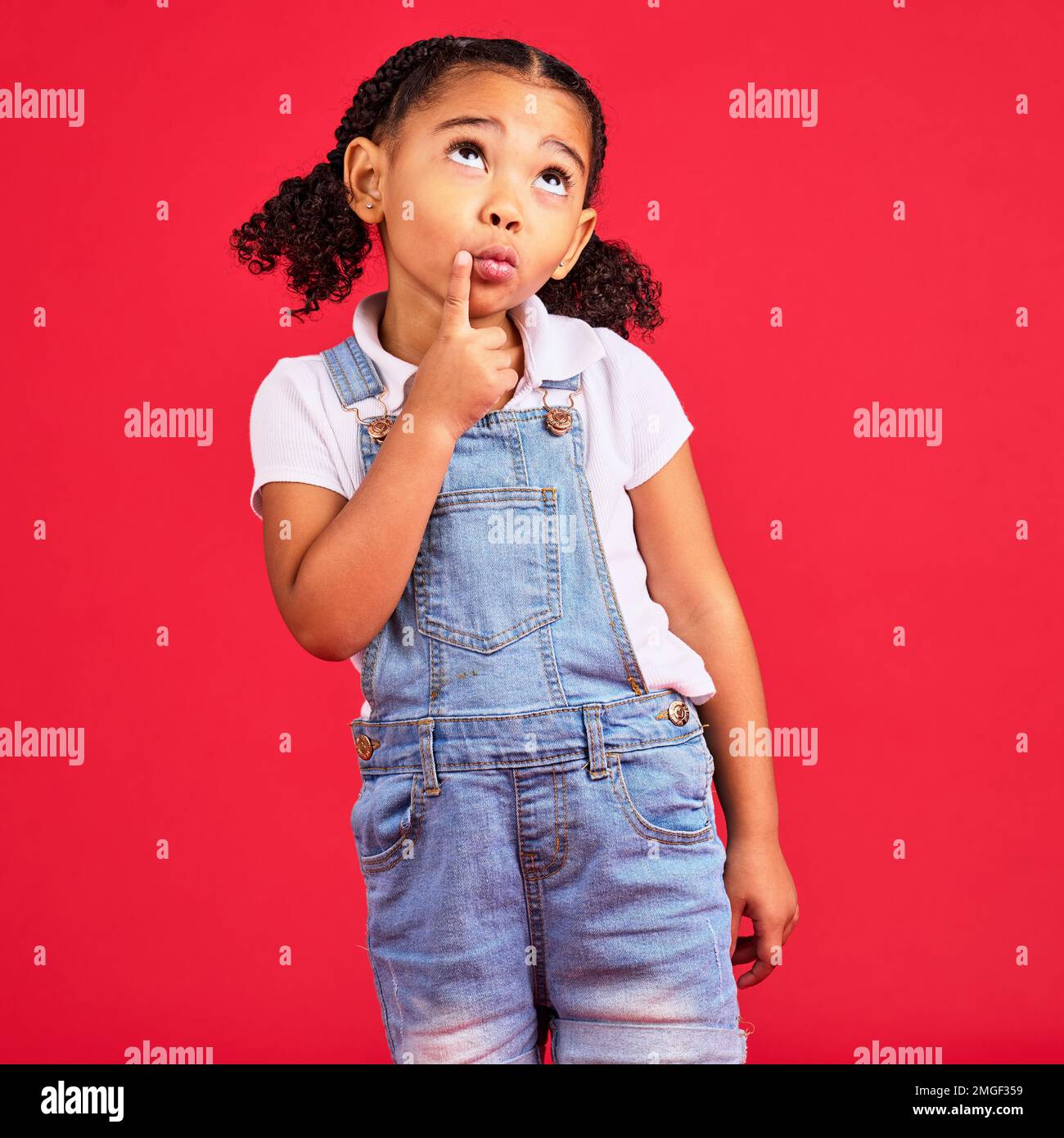 Kid, face or thinking finger on chin by isolated red background in games innovation, question or planning vision. Little girl, ideas or curious Stock Photo
