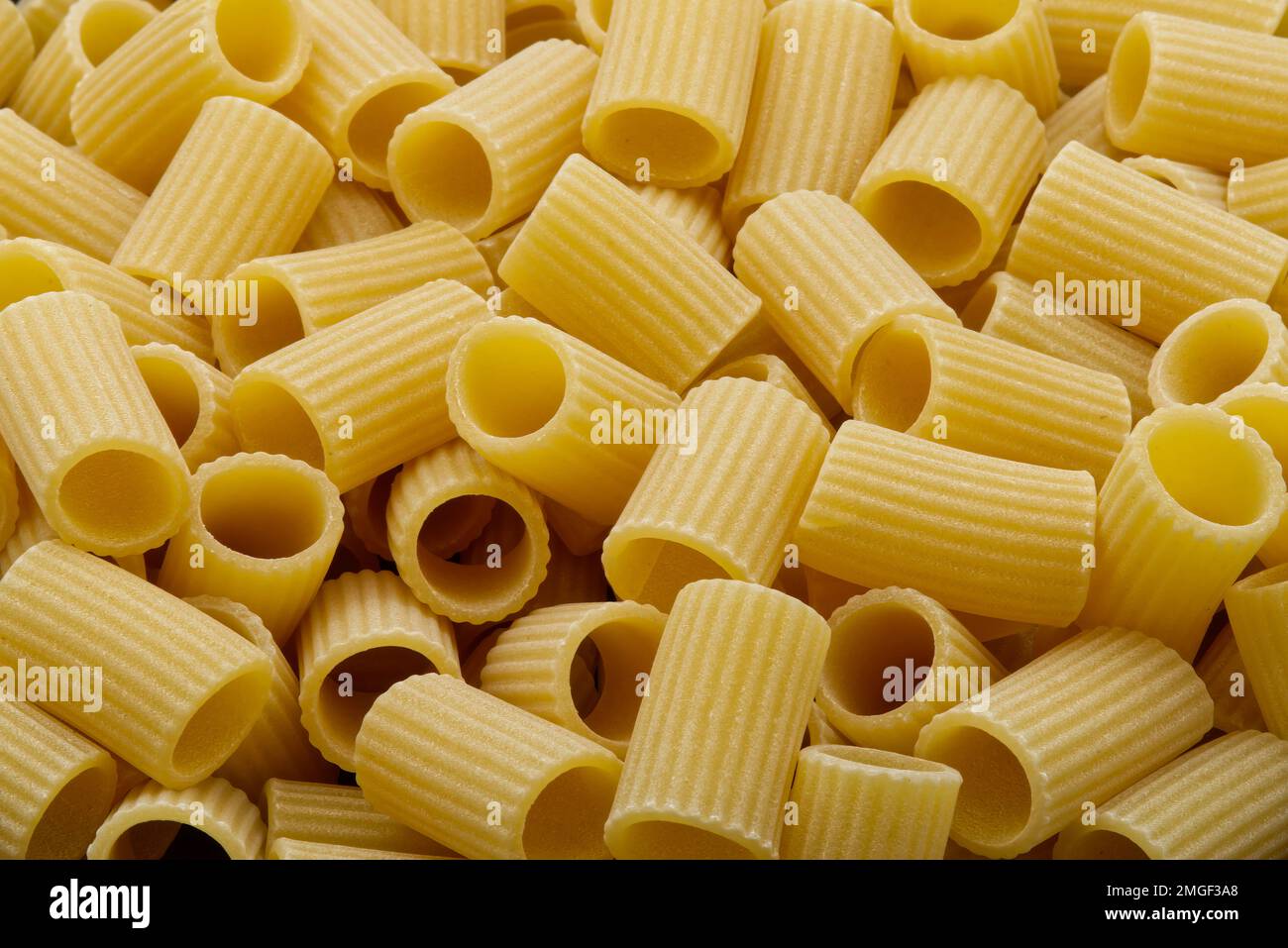Raw Mezze Maniche Rigate, Italian Pasta. Close-up. Stock Photo