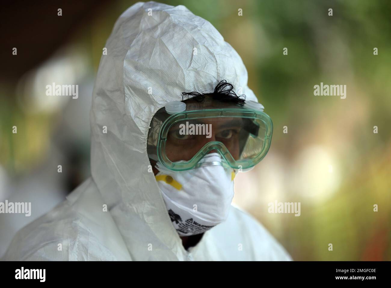 In this Wednesday, May 20, 2020, photo, an Afghan lab technician poses for a photo at the Afghan