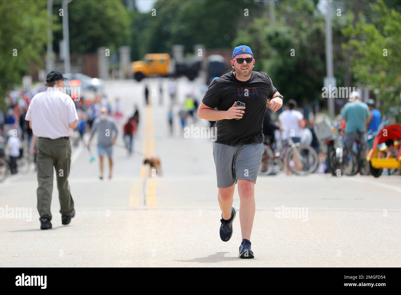 A runner trots by a crowd gathered outside of Fort McHenry National