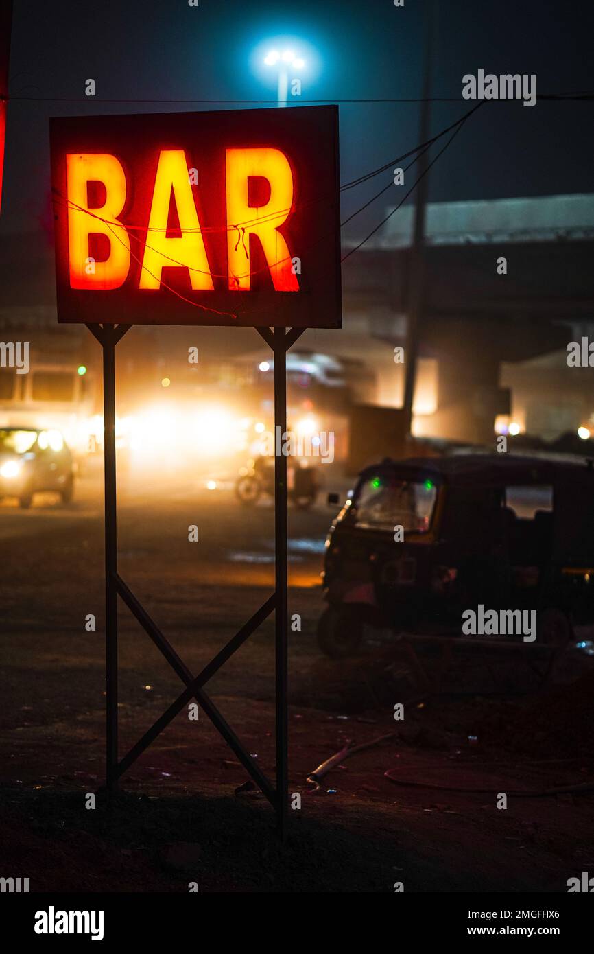 Bar light sign board in red color, neon sign for a bar,Bar neon sign,neon BAR sign lights up the doorway of a drinking establishment at night, a place Stock Photo