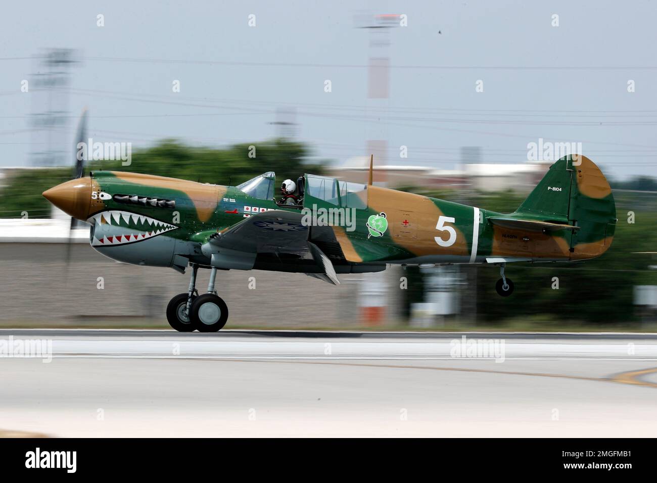 A vintage war aircraft from the Cavanaugh Flight Museum lands at Addison  Airport in Addison, Texas, Friday, May 22, 2020. The aircraft along with  other vintage war birds flew over several medical