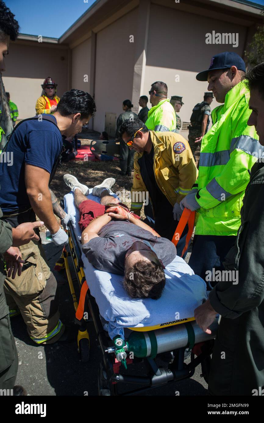 San Diego Emergency Services and Marine Corps Air Station Miramar Firefighters carry casualties