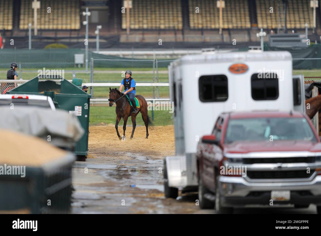 An exercise rider is seen on a horse at Pimlico Race Course, Friday ...