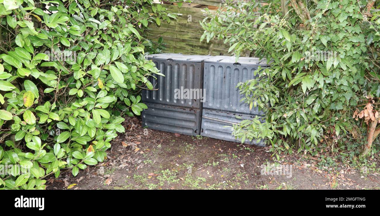 Black plastic composting bin for Making compost from green waste Stock