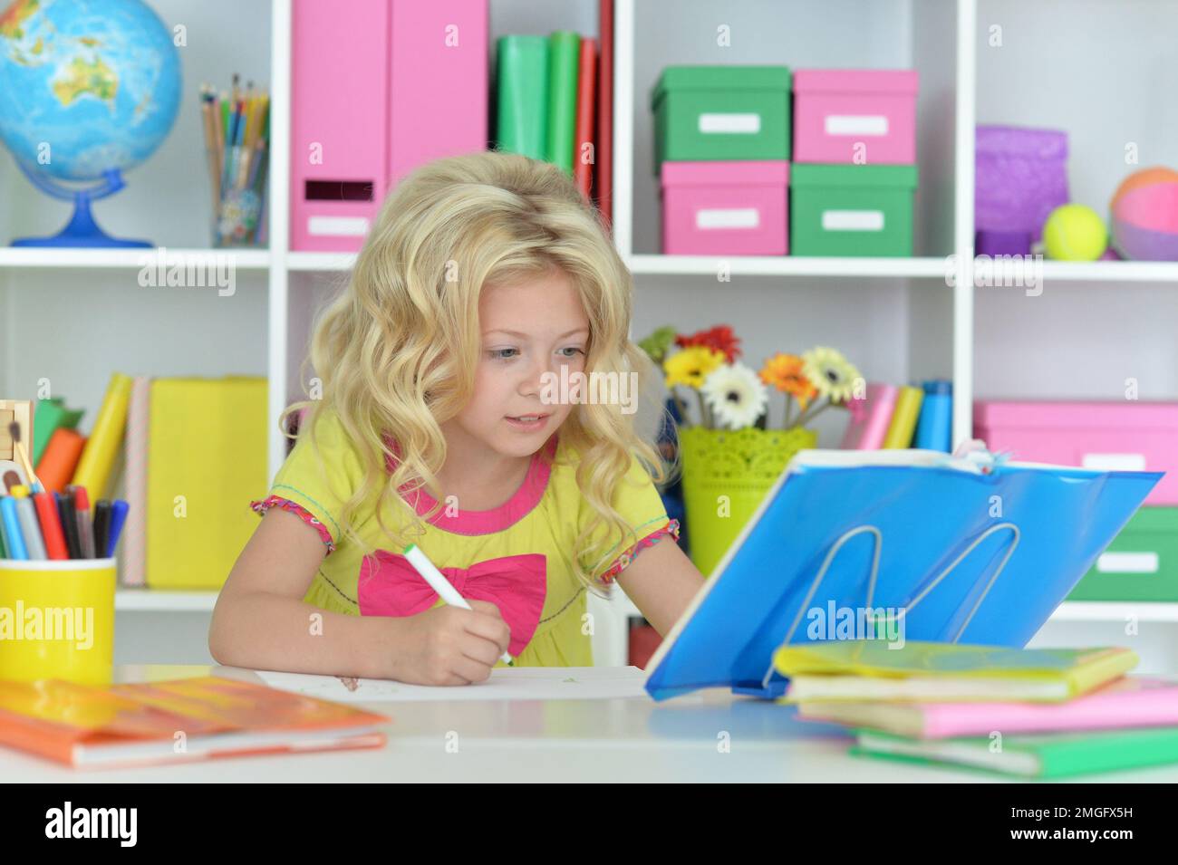 little girl studying at home at the table Stock Photo - Alamy