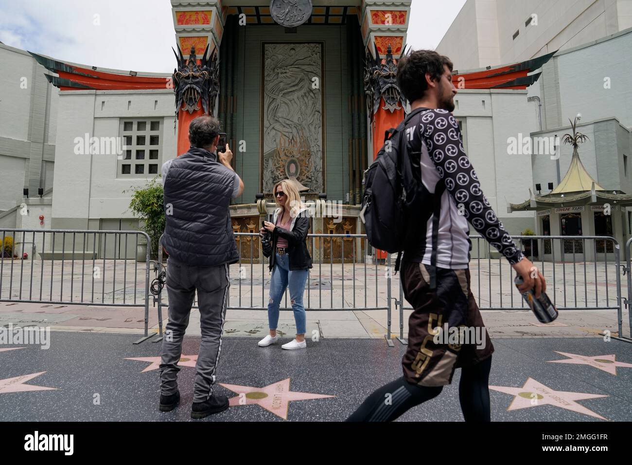 People walk and take photos on the Walk of Fame outside TCL Chinese ...
