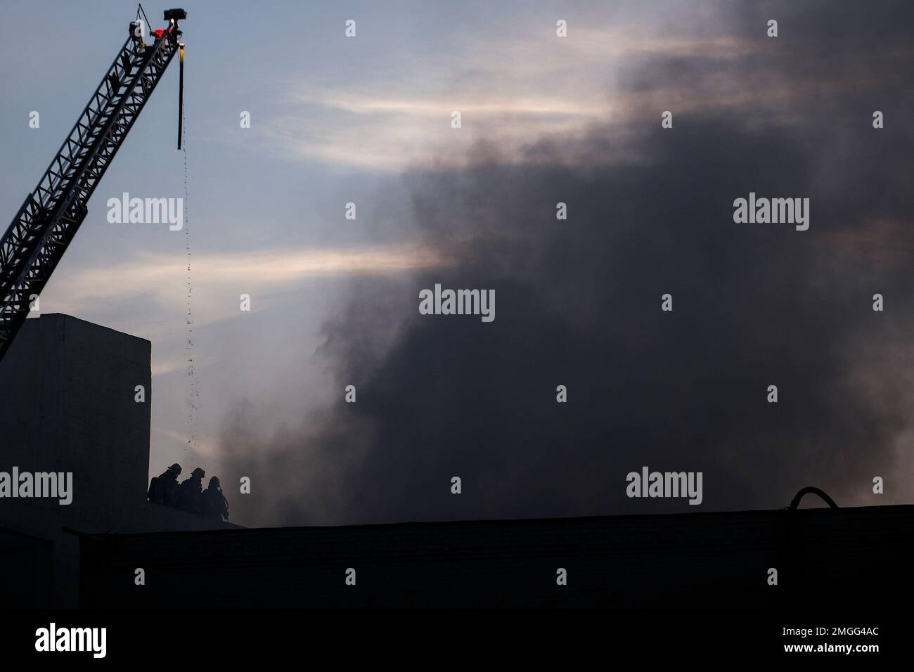Los Angeles Fire Department firefighters work the scene of a structure ...