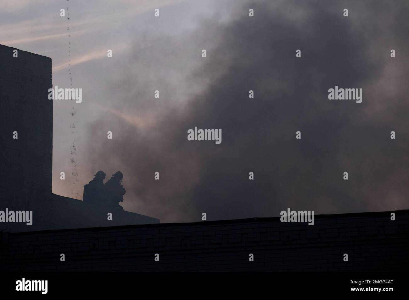 Los Angeles Fire Department firefighters work the scene of a structure ...