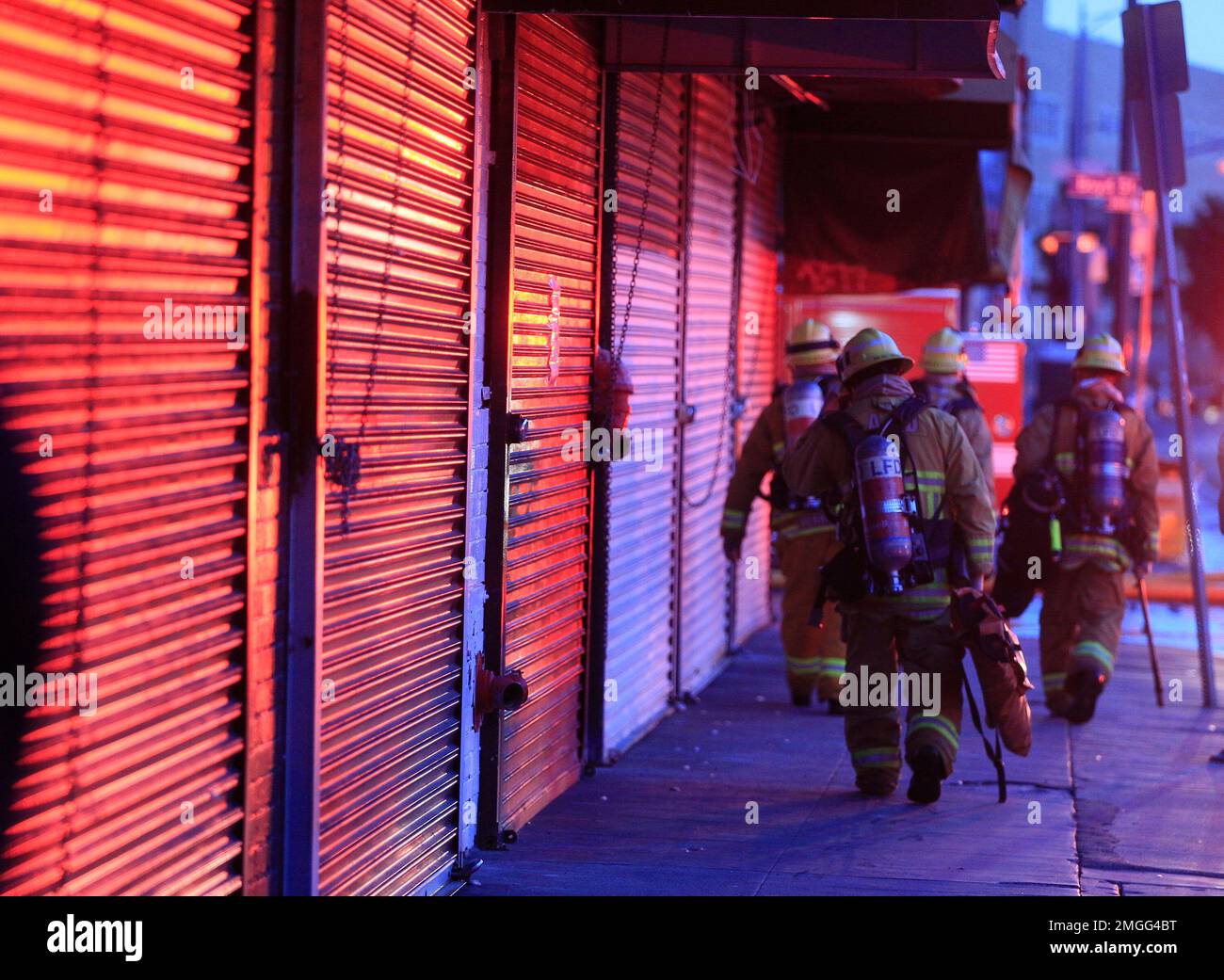 Los Angeles Fire Department firefighters wear oxygen tanks as they work ...