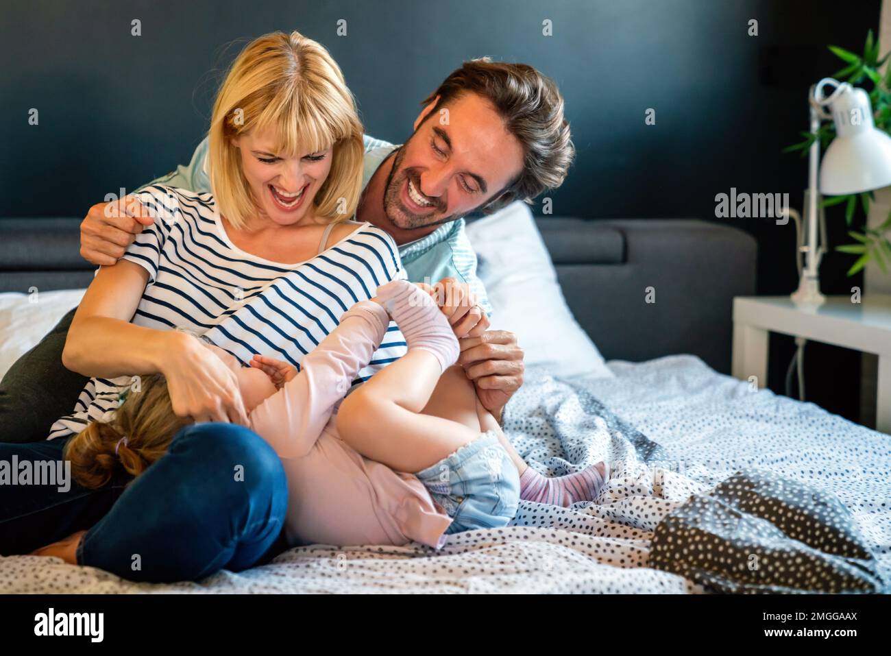 Young family being playful at home. People parent child fun happiness concept. Stock Photo