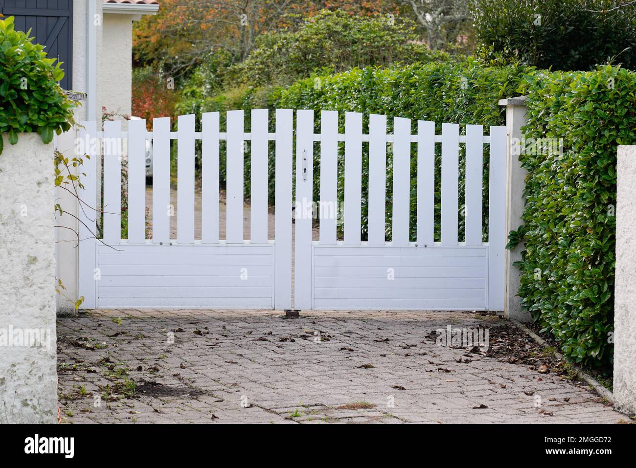 suburban pvc plastic gate white on home street access house garden Stock Photo