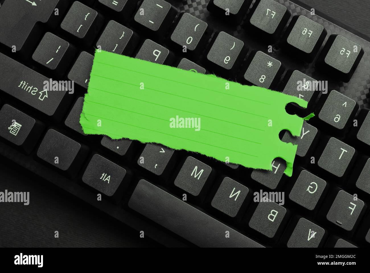 Colored sticker lying on keyboard. Important message written over paper. Stock Photo