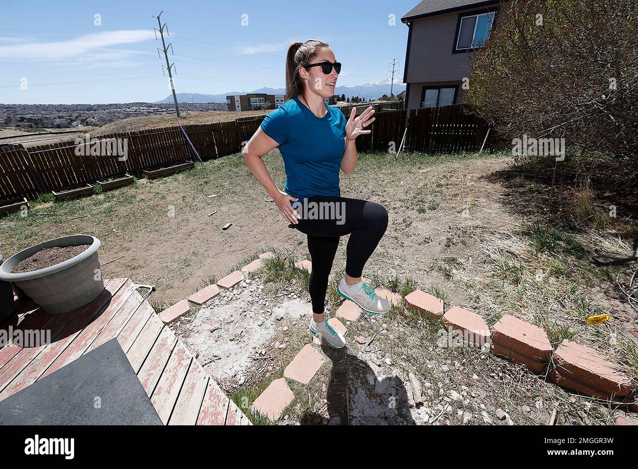 Olympic javelin competitor Kara Winger runs stairs to warm up before training outside her home