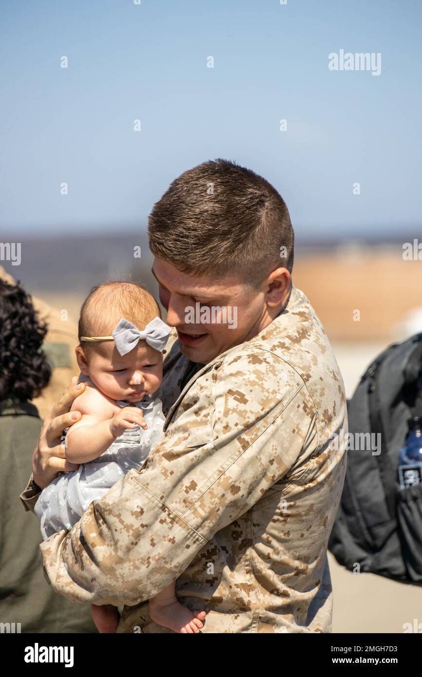 U.S. Marine Corps Cpl. Daniel Meyers with Marine Aerial Refueler Transport Squadron 352, Marine Aircraft Group 11, 3rd Marine Aircraft Wing, embraces his child at the Combined Joint Task Force-Horn of Africa homecoming, on MCAS Miramar, California, Aug. 22, 2022. The deployment was a successful integration of elements of three Fleet Marine Force squadrons to provide critical rapid personnel recovery and medical evacuation capabilities to U.S. and partner forces operating in East Africa. Stock Photo