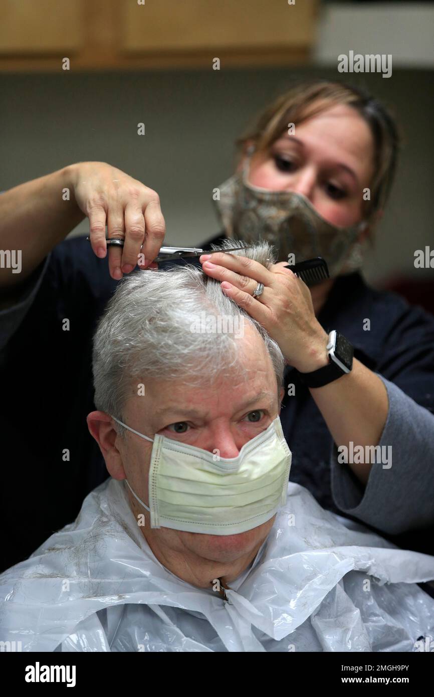 Ann Fouquette cuts Jan Smith's hair at Kilroy's Haircutters, Friday