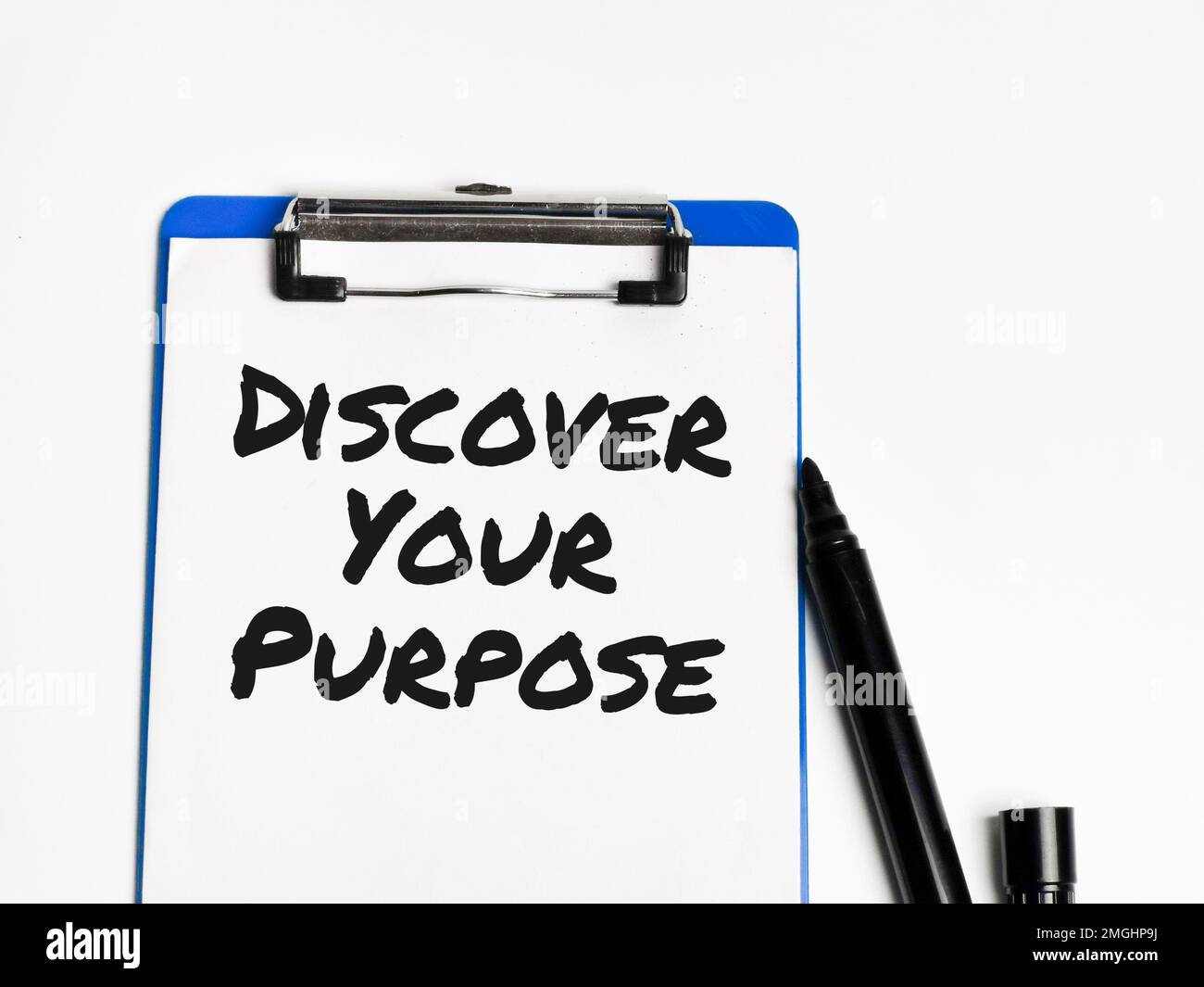 Phrase discover your purpose written on paper clipboard against white background. v Stock Photo