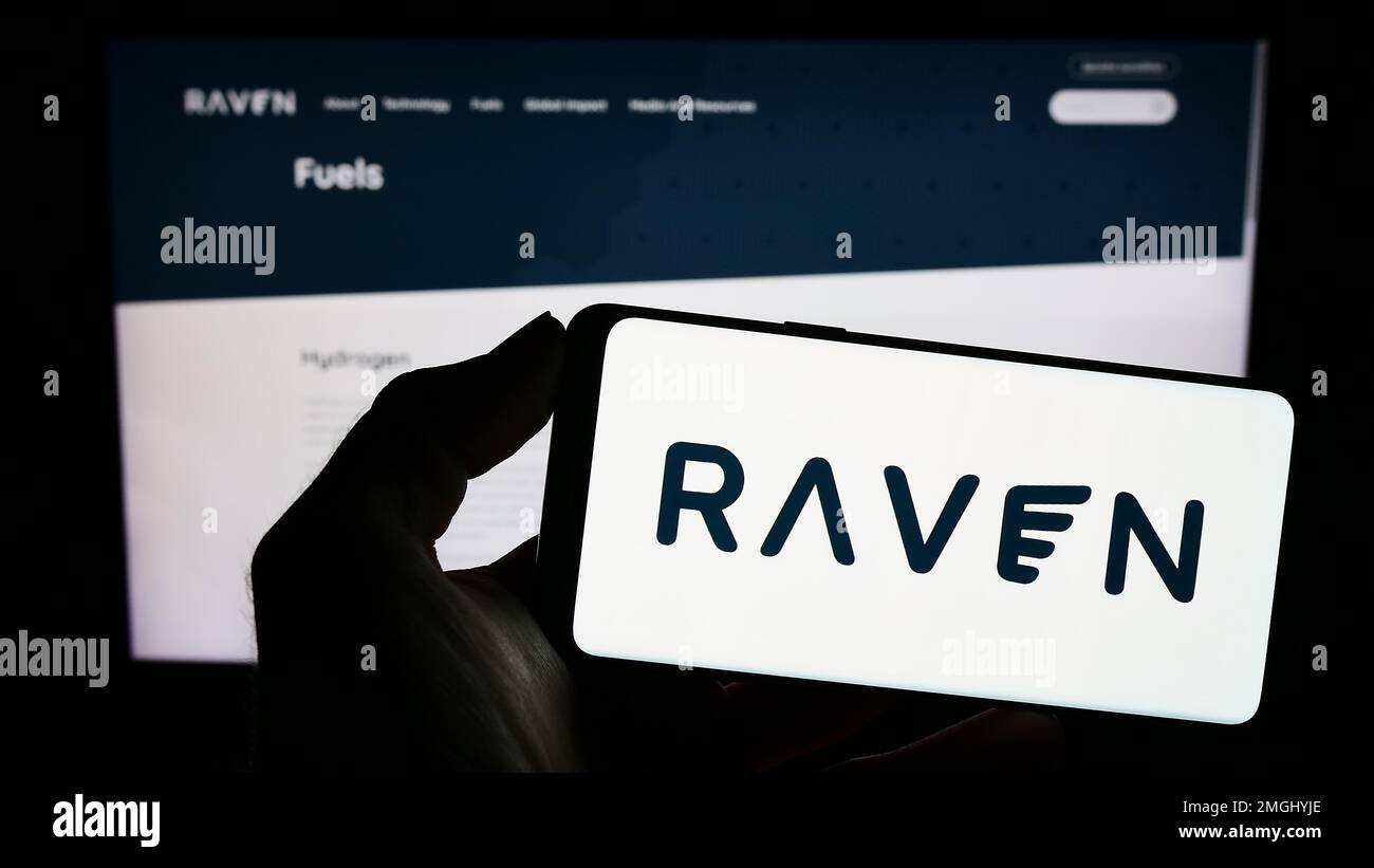 Person holding cellphone with logo of US renewable fuels company Raven SR Inc. on screen in front of business webpage. Focus on phone display. Stock Photo