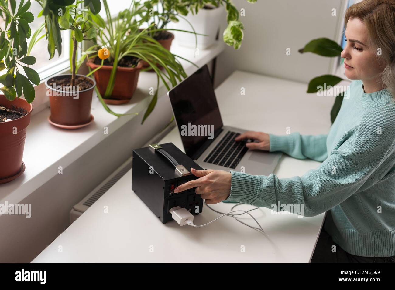 Charging station for phone, tablet, laptop and other gadgets when there is no light during blackout. Generator power bank battery in the absence of Stock Photo