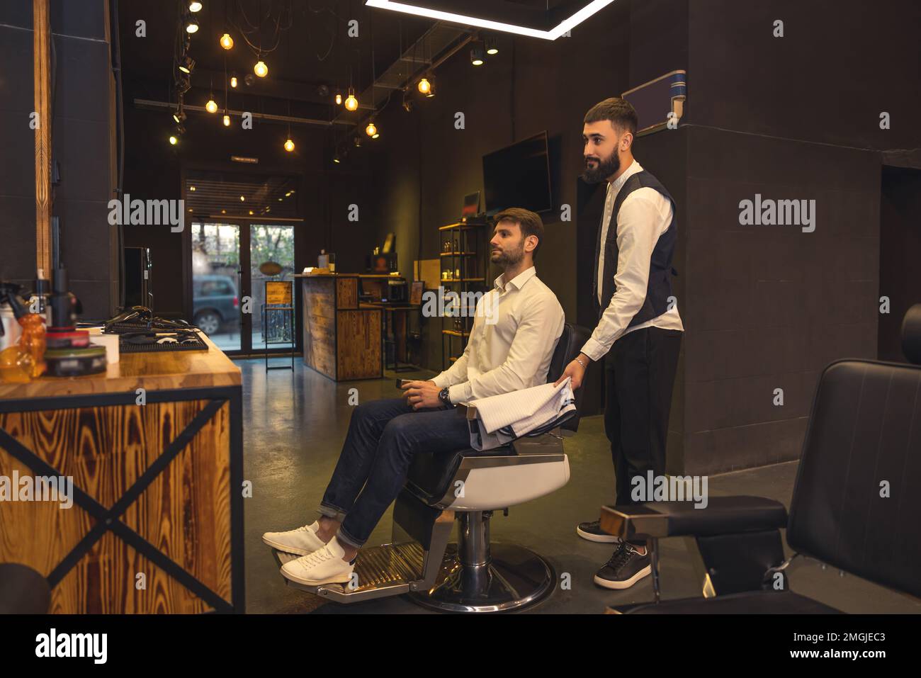 Professional male hairdresser working with the client Stock Photo