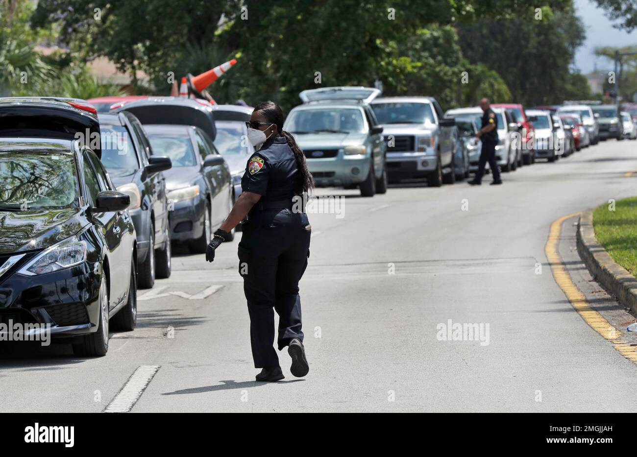 Opalocka, Fla., Police officers control traffic at a drivethru food