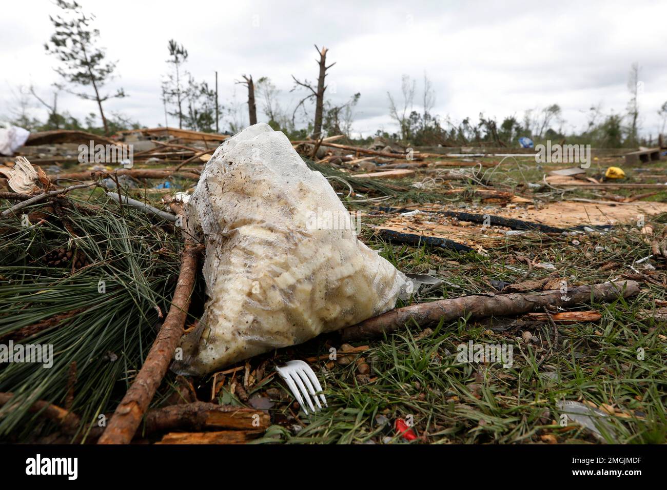 A bag of uncooked french fries rests near a tornado swept Mama D's Bar
