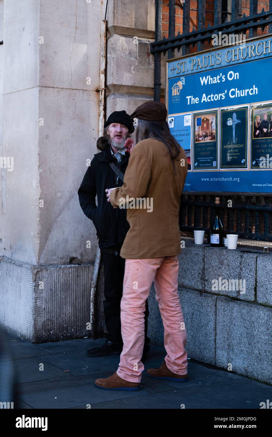 London - 02 27 2022: two homeless people in covent garden talking and drinking Stock Photo