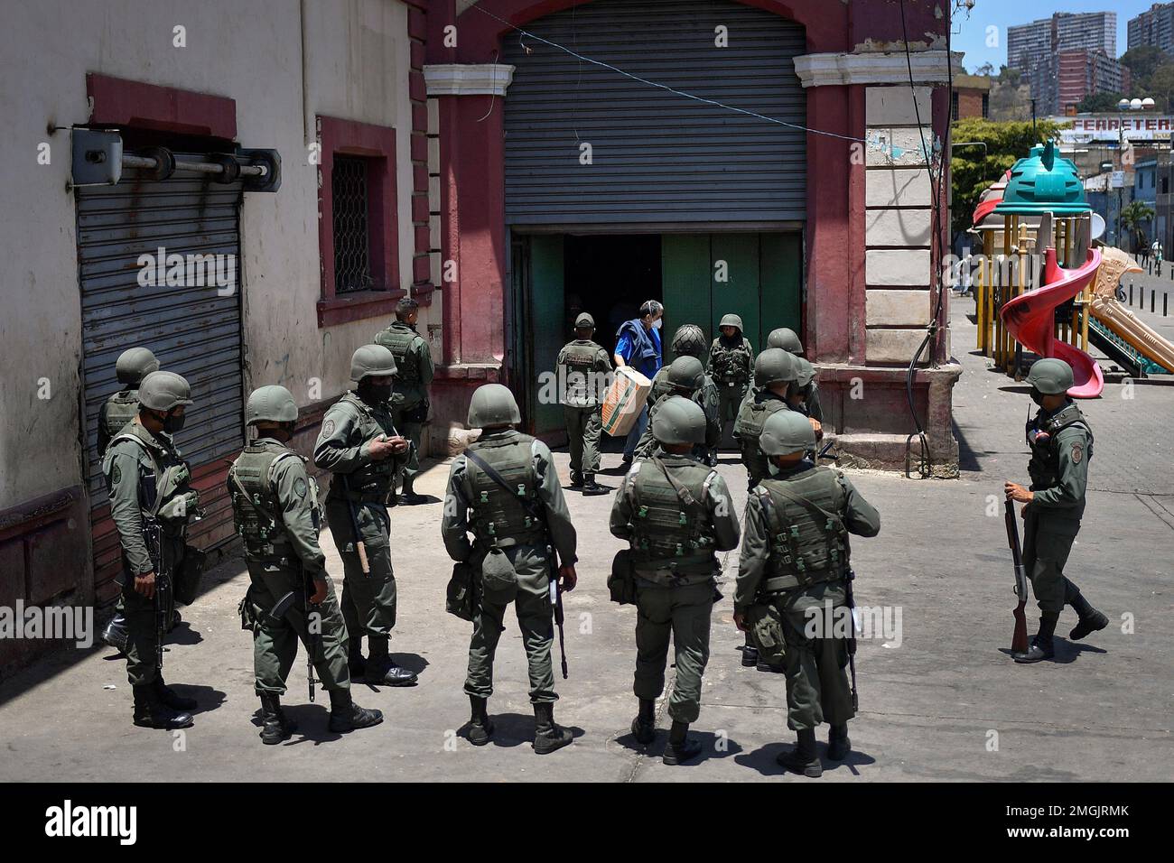 Soldiers, wearing face masks as a precaution against the new coronavirus, stand guard outside