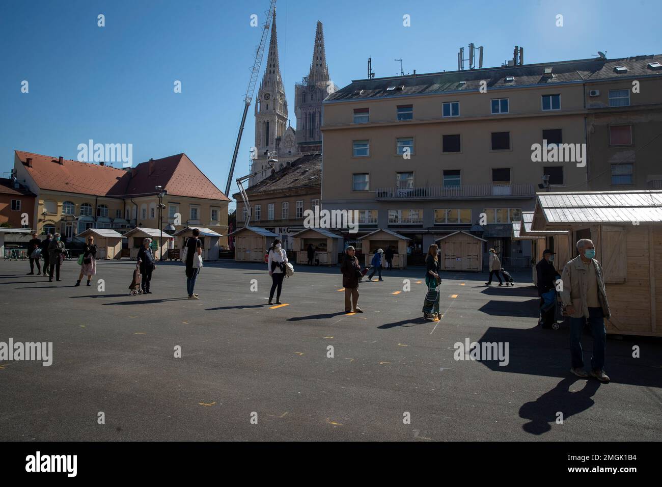 Buyers wait in line at the open air food market in downtown Zagreb