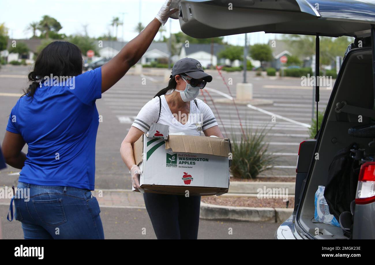 Volunteers from Phoenix College hand out St. Mary's Food Bank donated