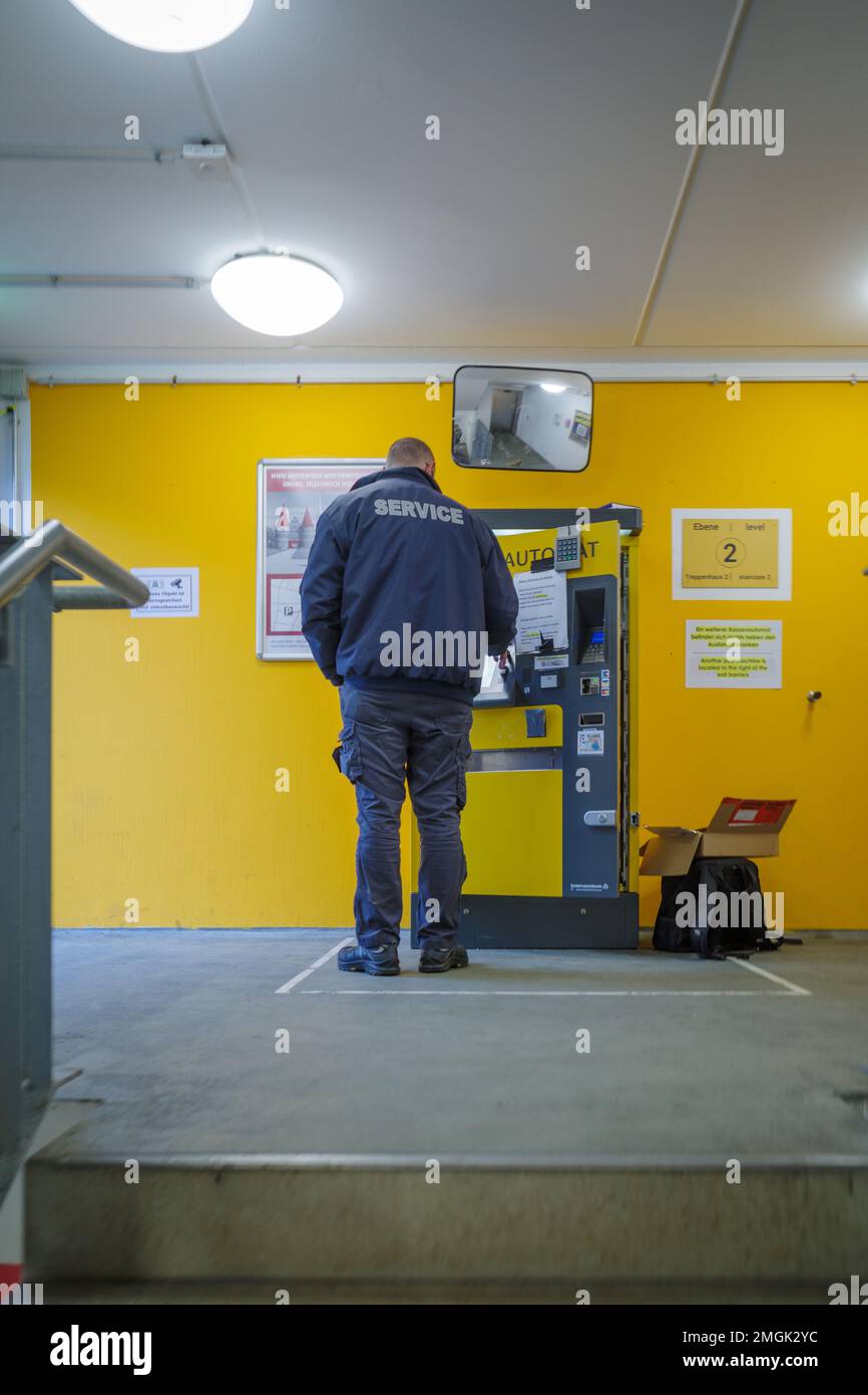 a technician repairs a pay station in a parking garage Stock Photo Alamy
