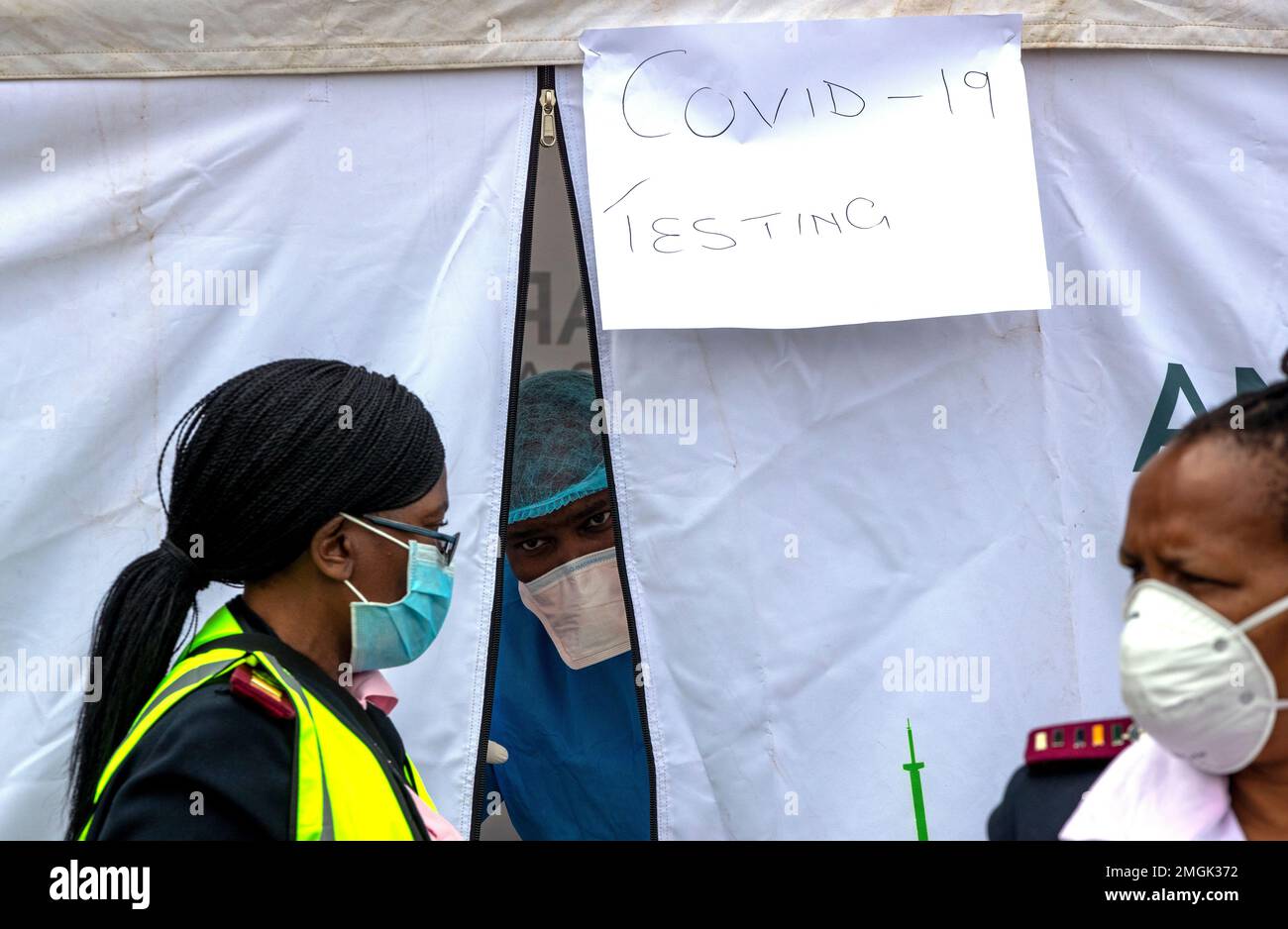 A health worker wearing personal protective gear inside a testing tent