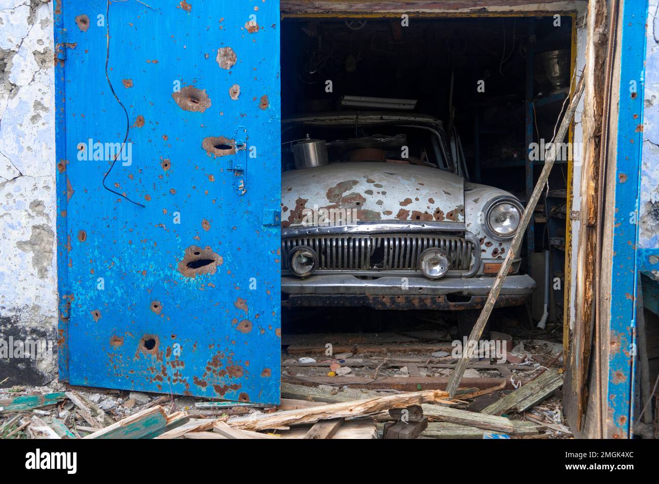 Destroyed civilian car is in the garage. On the body of the car there ...