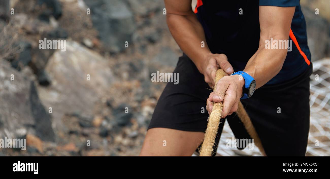 Running over obstacles race,defeating obstacles by using ropes Stock Photo