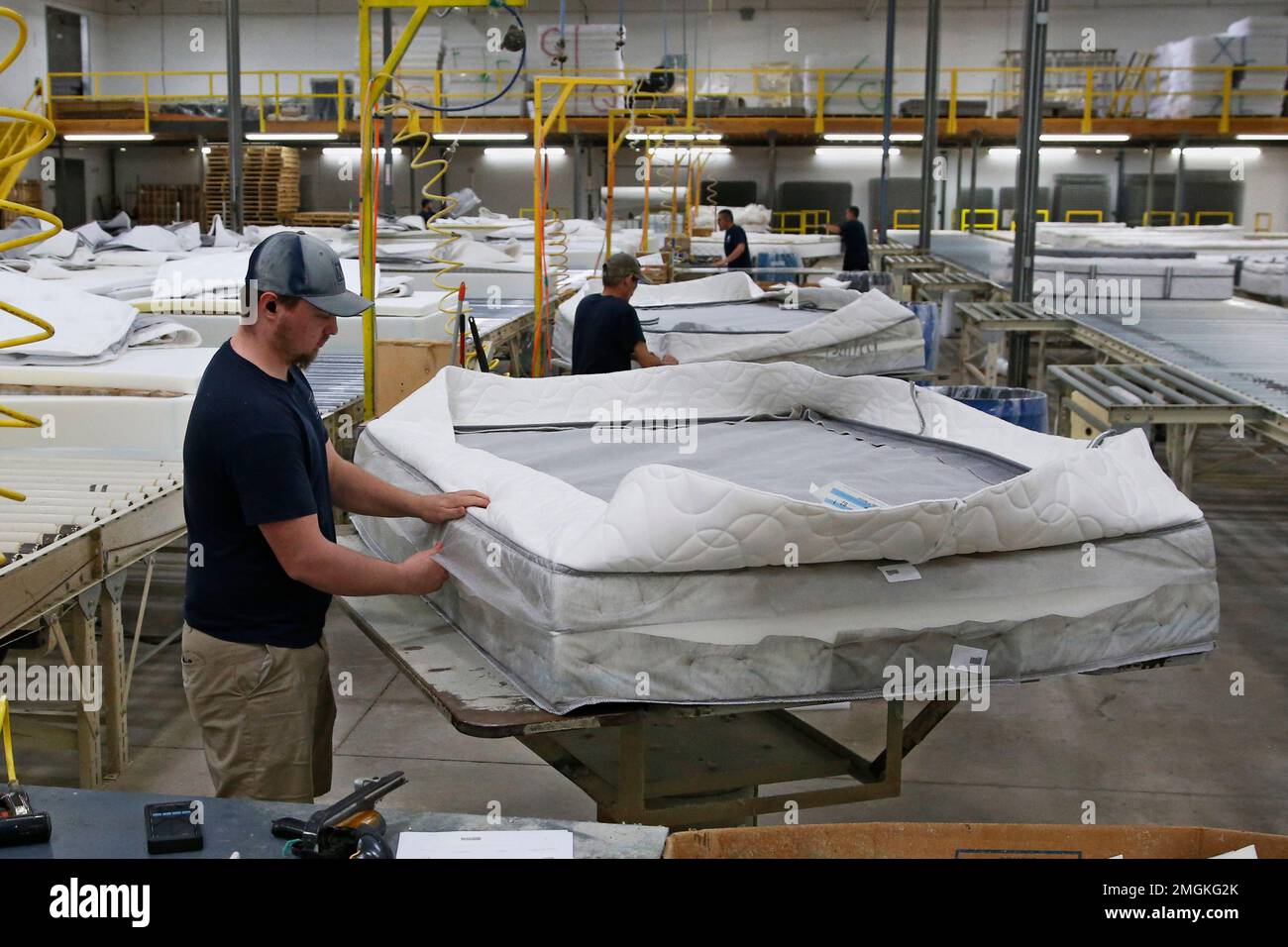Workers at the Mathis Brothers mattress factory continue construction mattress as part of the factory has been given over to sewing mask for hospital use Wednesday April 1 2020 in Oklahoma City
