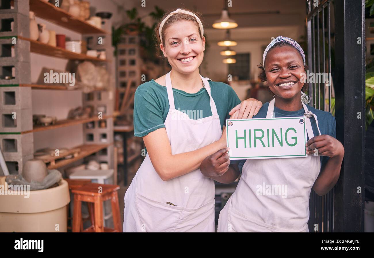 Hiring sign, portrait and people or business owner in diversity recruitment, career opportunity or store offer. Black woman, partner and retail Stock Photo