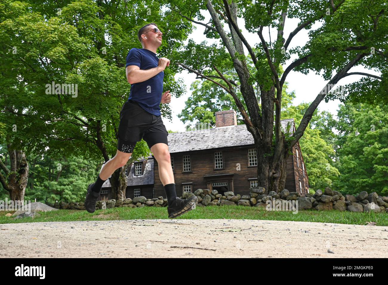 Staff Sgt. Jordan Rhea, 319th Recruiting Squadron NCO in charge of personnel section, runs past the Hartwell Tavern during a Battle Road 10 K race at the Minuteman State Park in Lincoln Mass., Aug. 24. Tech. Sgt. Matthew Ruscitti, 319th Recruiting Squadron NCO in charge of operations, was the overall male winner and Dannie Wu, Contracting Directorate price analyst, was the overall women’s winner. Stock Photo