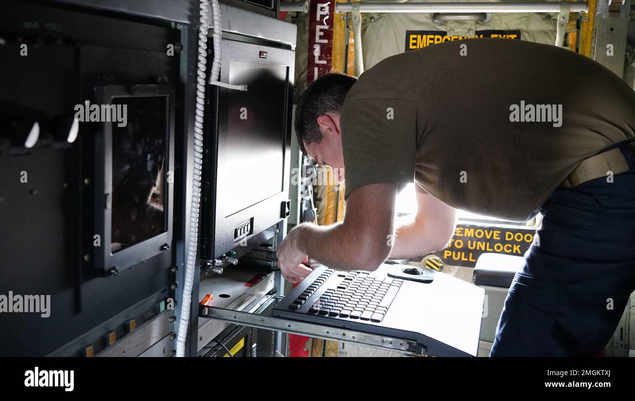 Tech. Sgt. Mason Henry, 403rd Maintenance Squadron metereological equipment technician, changes out the outdated computer system for an updated one on the dropsonde operator pallet on the WC-130J Super Hercules completing an upgrade on the system August 24, 2022. Stock Photo