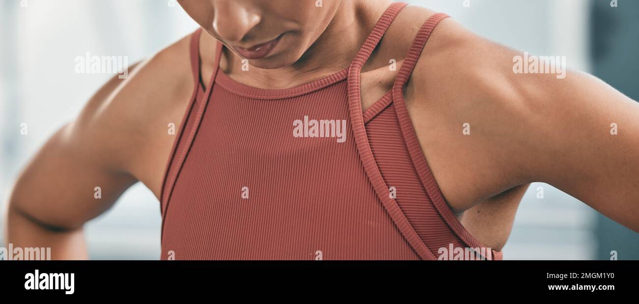 Fitness, tired and breathing with the shoulders of a black woman in the gym after a workout for health. Exercise, exhausted and breath with an athlete Stock Photo