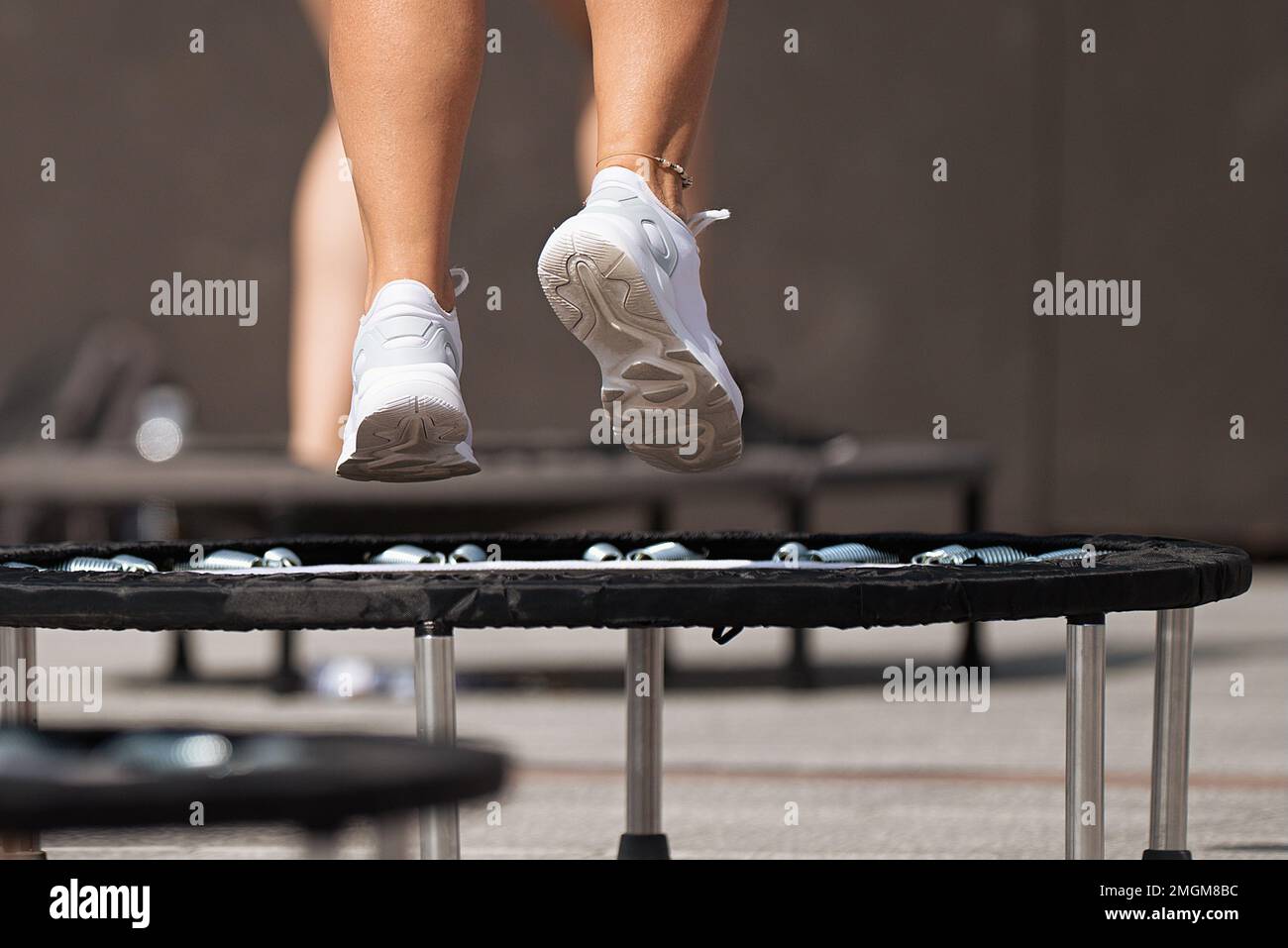 Fitness women jumping on small trampolines,exercise on rebounder Stock