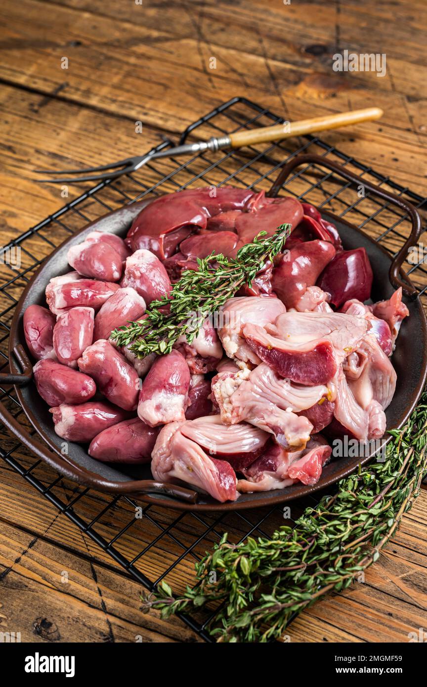 Raw bird giblets meat set, chicken offals, liver, hearts, gizzards